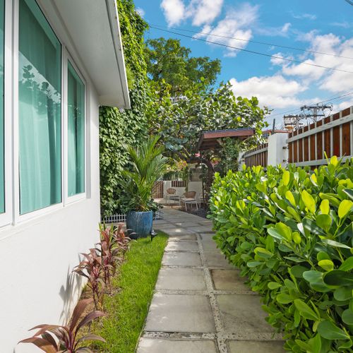 A tranquil walkway with lush plants and a cozy atmosphere.