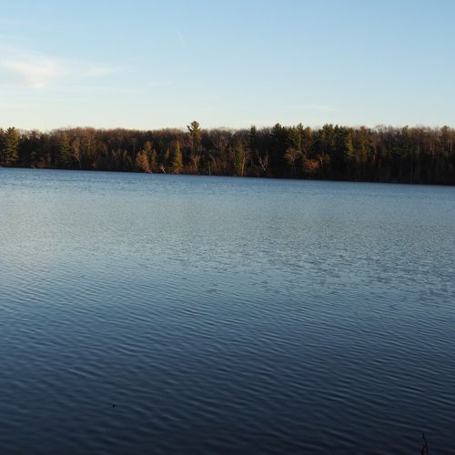 This is a november, 2020 photo of beautiful green lake from the private lake access area. Note that the opposite side of the lake is a nature preserve and new construction is not permitted there.