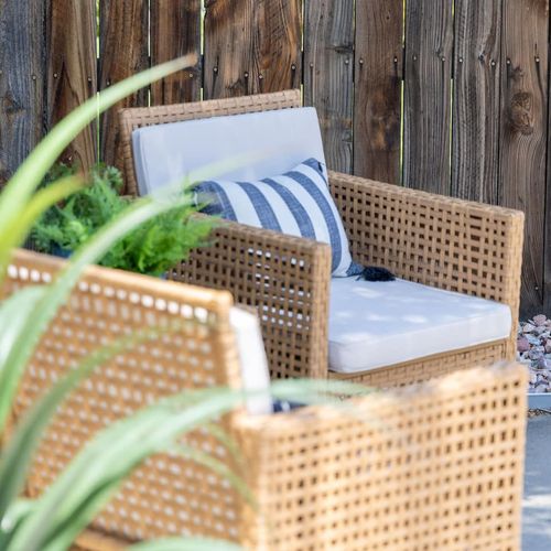 - cozy up in one of the woven armchairs topped with plush cushions and a striped pillow
- enjoy intimate conversation or a quiet moment with a favorite book
- surrounded by greenery and natural textures for a soothing outdoor feel