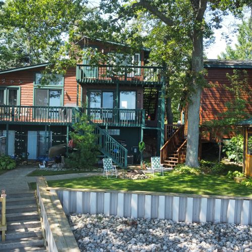 Exterior:  the back of the house, which faces the lake. The apartment is shown at the top of the photo.