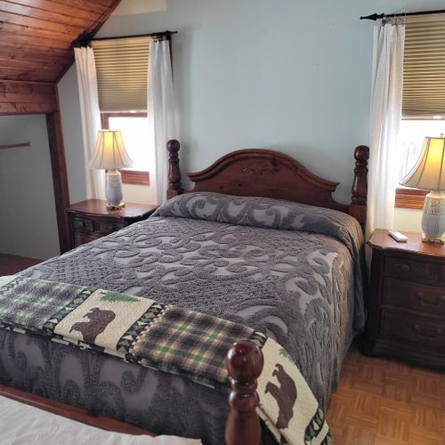 Bedroom #2 (second floor):  very large bedroom features a queen-size bed, walk-out deck, chair, 2 nightstands, 2 lamps, 2 dressers, ceiling fan, television, and private en suite full bathroom