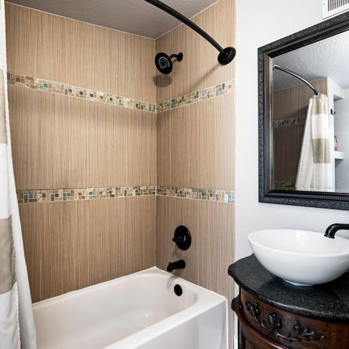 This bathroom features a tub/shower combo, toilet, and sink. Toiletries are provided for your convenience.