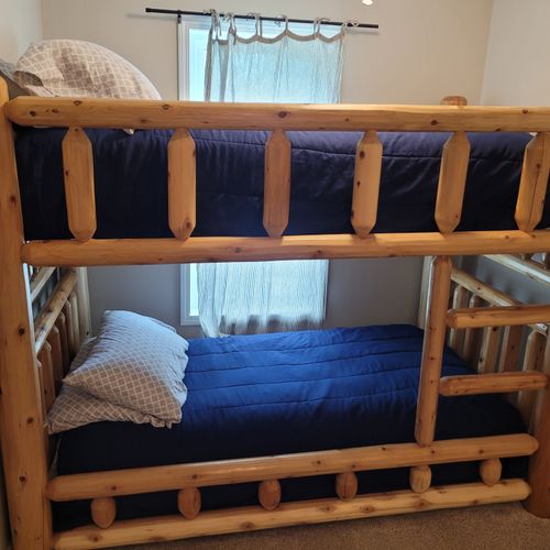 Bedroom #2:  features a twin-on-twin bunk bed, dresser, closet, and lamp