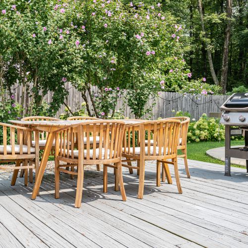 Calling all grill enthusiasts! Serve up a delicious feast for your guests while enjoying views of the in-ground pool and serene wooded backyard.