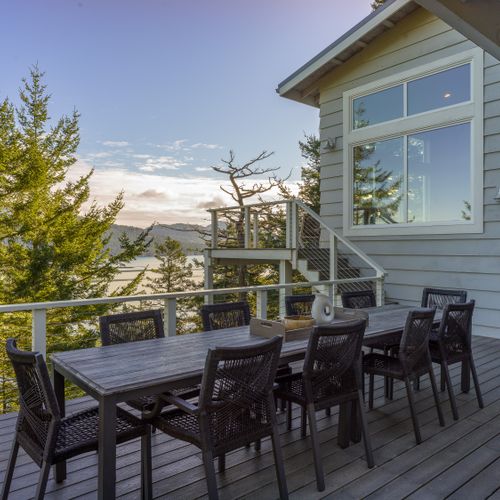 Outdoor seating for twelve guests right outside the dining room makes dining al fresco easy.