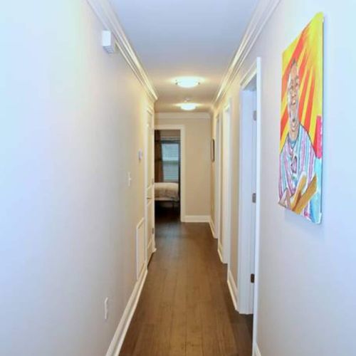 Colorful hallway w/ artistic murals adding a local, creative touch.
