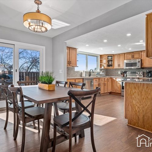 - bright dining area with a wood table, black chairs, & contemporary chandelier
- sliding doors let in natural light & offer access to the deck for indoor outdoor meals
- open to the kitchen, it’s perfect for family dinners or casual brunches at home