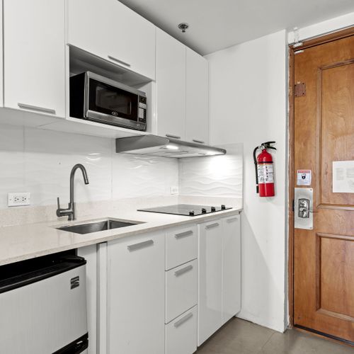 Sleek, modern kitchenette with all essentials, perfect for convenient meal prep during your stay.