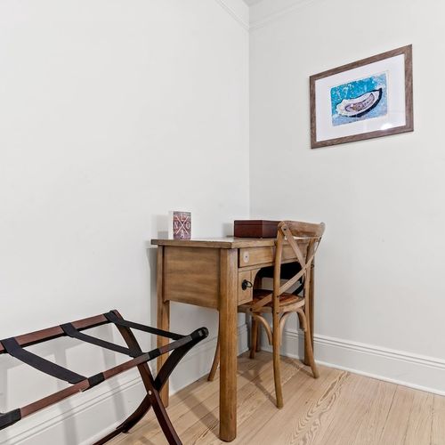 Bedroom nook w/ a wood desk — ideal for a quiet work-from-home moment.