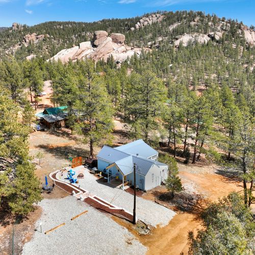 A peaceful mountain escape, high above and hugged by pines.