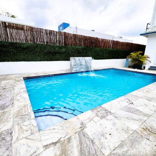 Dive into relaxation! Our sparkling clear pool awaits, surrounded by comfortable loungers perfect for soaking up the sun and enjoying the serene ambiance of your private getaway