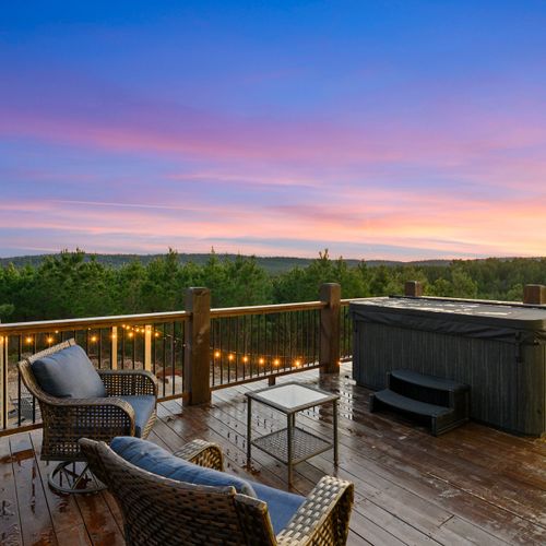 The deck is home to outdoor seating and a hot tub fitting 8 people!