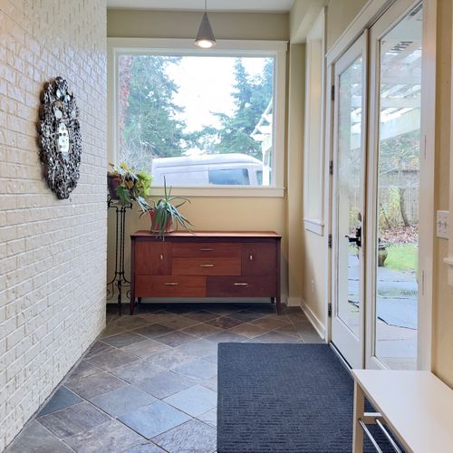 Bright and welcoming entryway with slate floors, natural light, and easy access to the outdoor patio—perfect for arriving, unloading, and easing into your stay.
