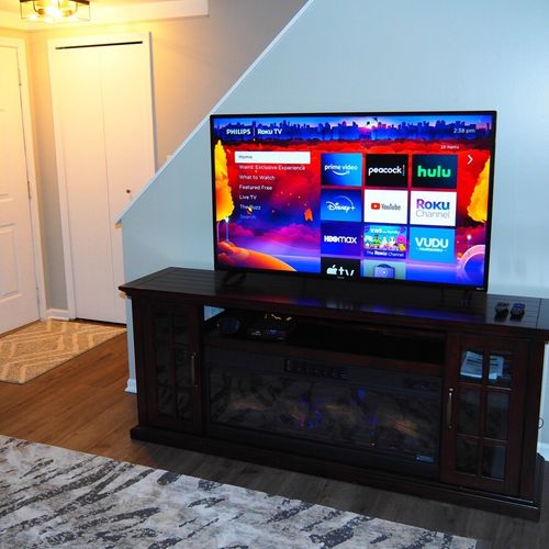 Living room:  very comfy and cozy living room with a sofa, comfy chairs, large television with living streaming, and a very cool electric fireplace.
