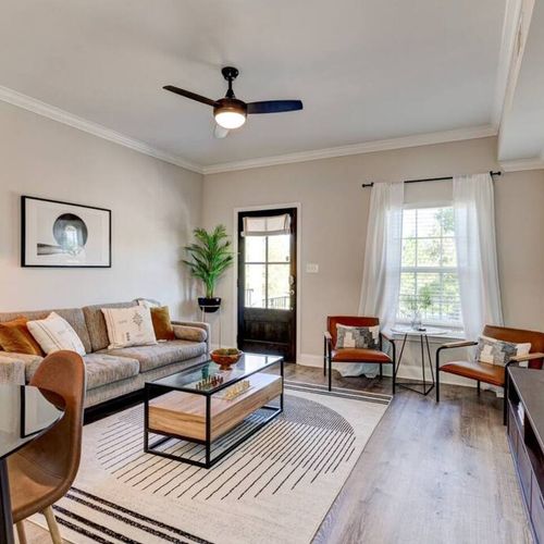 Bright, stylish living room w/ modern décor & ample seating — perfect for gathering after a day out.