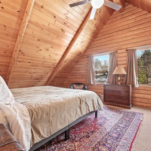 Bedroom #2 (second floor):  features a king-size bed, chair, dresser, ceiling fan, closet, and nightstand.