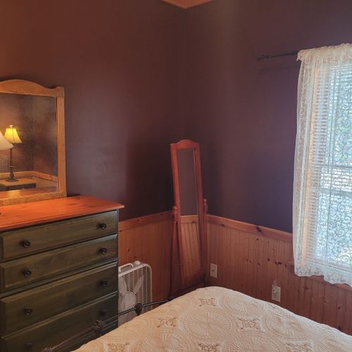 Bedroom #1 (main floor):  features a queen-size bed, dresser, mirror, nightstands, and lamps.