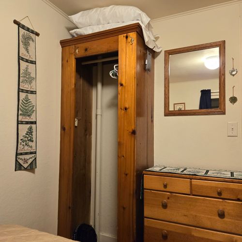 Bedroom #2:  features a full-size bed, nightstand, lamp, and dresser.
