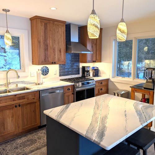 KITCHEN (MAIN FLOOR):  The home has a new and modern kitchen with all appliances including a dishwasher.  Also includes a coffee bar, kitchen island, and bar stools.