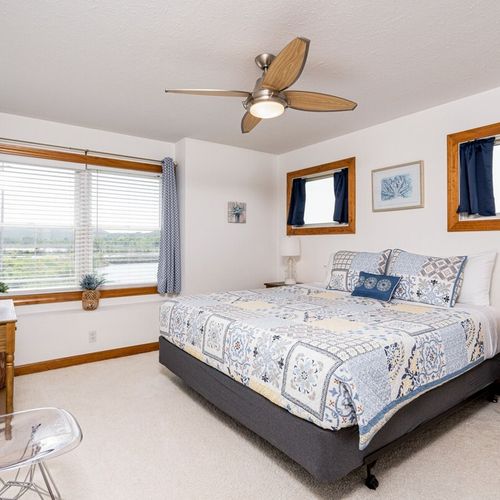Bedroom #3 (second floor):  features a king-size bed, dresser, closet, ceiling fan, and great views of betsie lake!