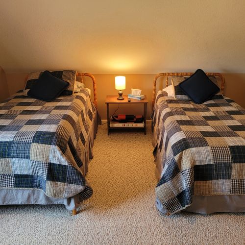 BEDROOM #2 (SECOND FLOOR):  Features a queen-size bed, 2 single beds, ceiling fan, a dresser, mirror, 2 nightstands, lamp, stool, and private live streaming television (via Sling).