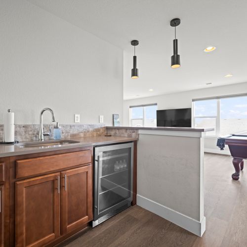 Top-floor hangout featuring wet bar and mini fridge.