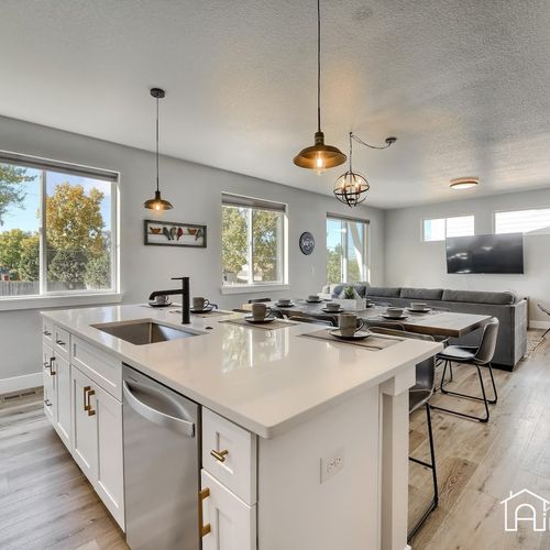 - central island connects seamlessly to the dining and living areas for easy entertaining
- multiple windows and clean finishes keep the space light, airy, and welcoming
- ideal for prepping meals while staying connected to the group