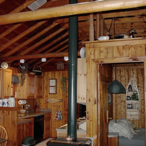 Living room:  the cabin has a very comfy and cozy living room with a sofa, comfy chair, gas fireplace, coffee table, and live streaming television with roku