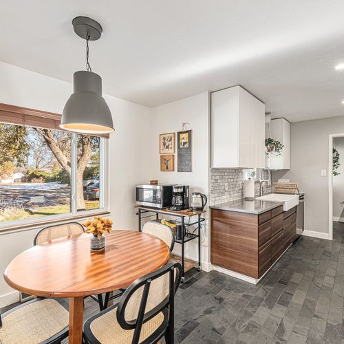 Charming breakfast nook by the window, perfect for starting your day in a cozy, sunlit spot.