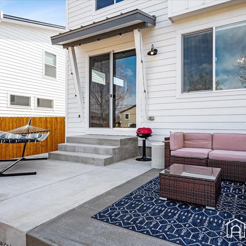 Slide open the glass doors and bring the outdoors inside with this backyard escape. Outfitted with a spacious sectional, 2 person