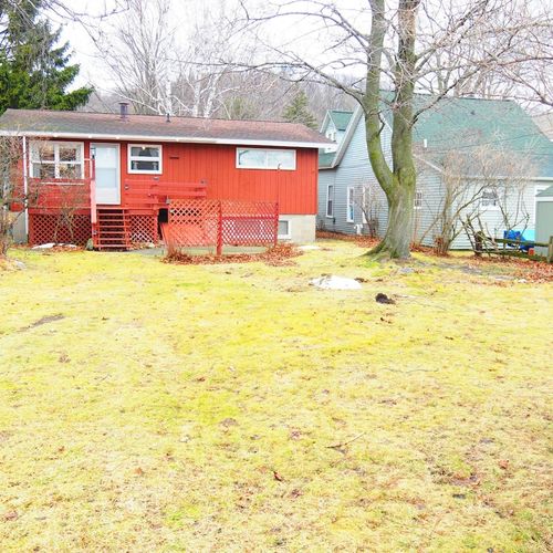 Exterior:  the back of the house in winter, showing the large parking area.