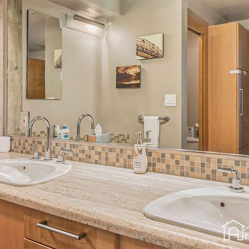 - dual sinks and plenty of counter space make this bathroom ideal for couples or shared stays
- mosaic tile backsplash adds personality to the modern design
- bright lighting and mirror space give it both function and hotel like style