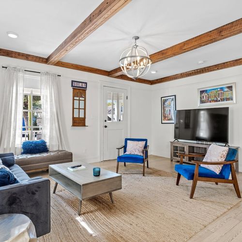 Living room w/ ample seating, TV & streaming services ready to go.
