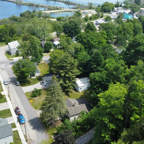 Exterior:  aerial view showing the street that the home is on and betsie lake in the background.