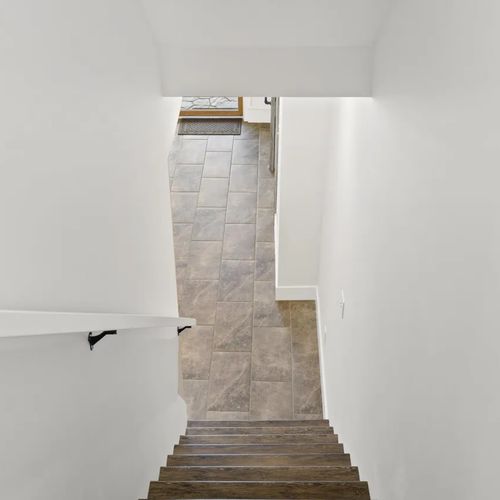 STAIRS:  These are the stairs down to the lower level (i.e. the first floor).  The first floor has 2 bedrooms, a bathroom, a wet bar, and a secondary washer and dryer.