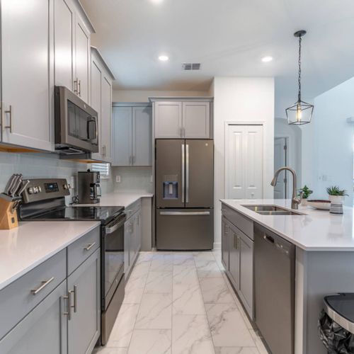 Modern Kitchen w/ Stainless Steel Appliances & Granite Counter Tops