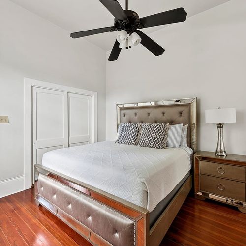 Sleep in luxury! This beautifully appointed bedroom features a plush bed, elegant decor, and ample natural light for a relaxing and restful stay.