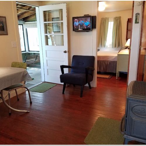 Living room:  the cabin has a cute little living room with a loveseat, dining table, and streaming television.