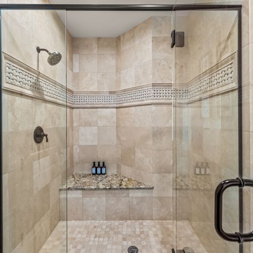 Spa vibes only—step into a designer bathroom with a rainfall shower, luxe fixtures, and plush towels.