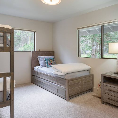 The main level bedroom offers bunk beds and a twin trundle bed for larger families.  This bedroom is ensuite and located right off the main entrance of the house.