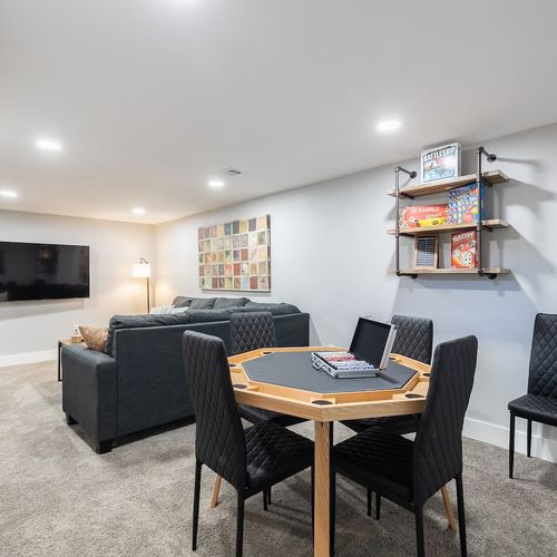 - cozy game room with a poker style table and shelves stocked with classics
- kick back on a comfy sectional while watching your favorite shows on the mounted flat screen
- perfect for game nights, movie marathons, or relaxed downtime with your group