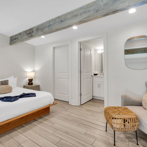 Spacious bed w/ seating area & direct ensuite access for added comfort.