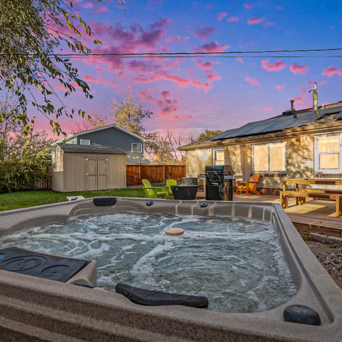 Unwind in the hot tub at dusk, surrounded by peaceful vibes and stunning views—your perfect spot for evening relaxation.