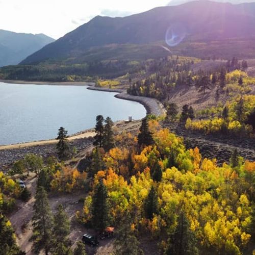 The crystal clear waters of twin lakes are surrounded by a sea of colorful autumn foliage in this aerial shot. Photo credit: jake jarvis