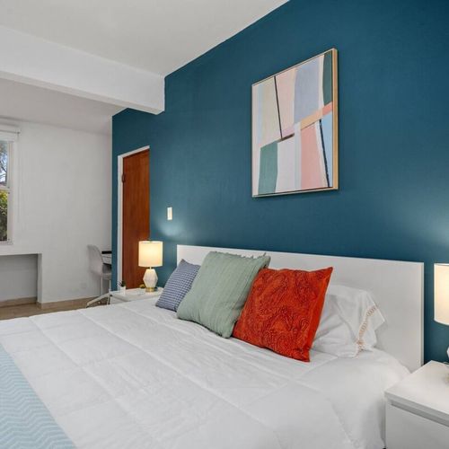 Unwind in a stylish, modern room with a cozy queen bed.