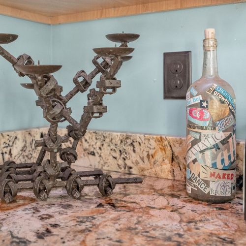 Antique candelabra beside a cozy sofa — moody, character-filled charm.