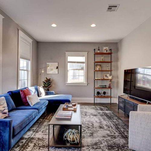 Cozy living room w/ blue sofa & warm tones — a welcoming spot to unwind after a day out.