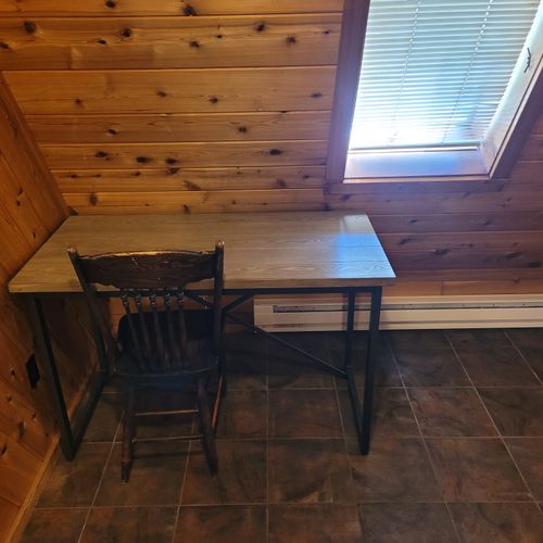 Bedroom #1 (main floor):  features a queen-size bed, private en suite bathroom, desk, dresser, mini-fridge, microwave, portable a/c unit, and its own private entrance.