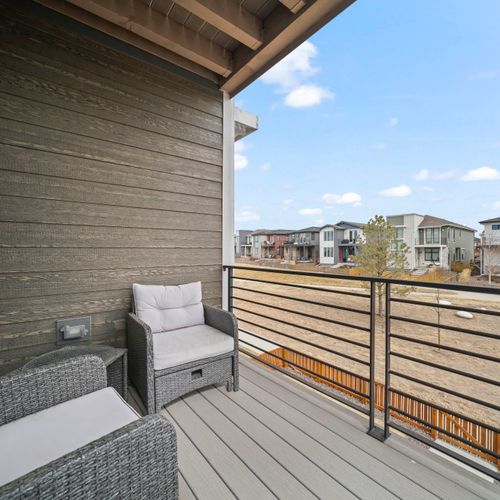 Private balcony hangout with fresh air and neighborhood views.