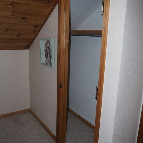 Bedroom #4 (upstairs):  features a twin-on-twin bunk bed, table, and a closet.